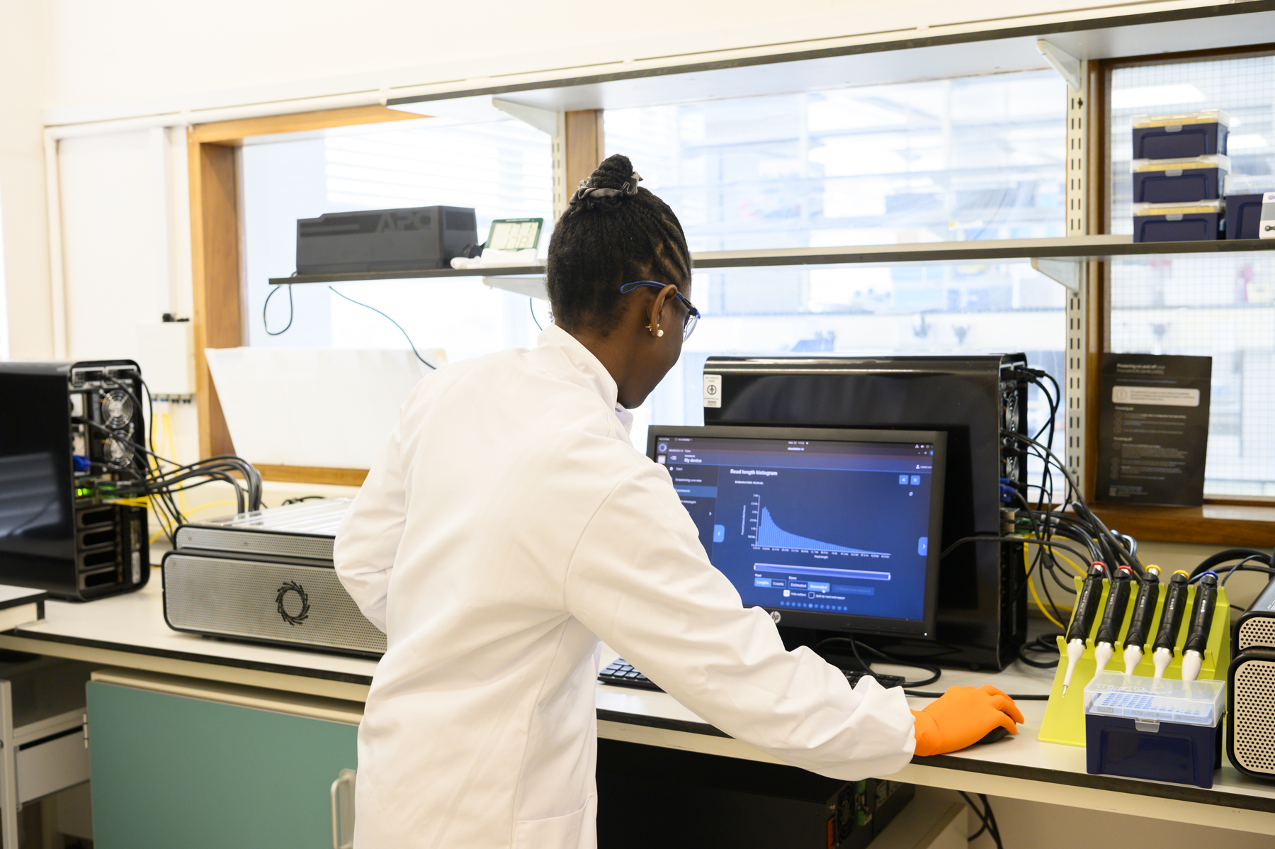 Our laboratory technician, Alimat, reviewing the output of the sequencing run conducted on the PromethIONs