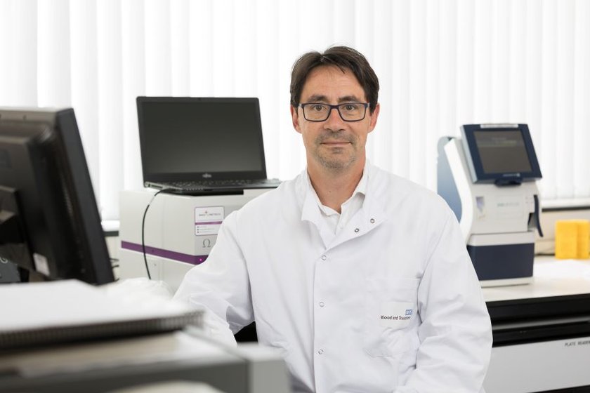 Co-chief investigator Cedric Ghevaert, consultant haematologist at CUH, sitting my lab equipment and computers.