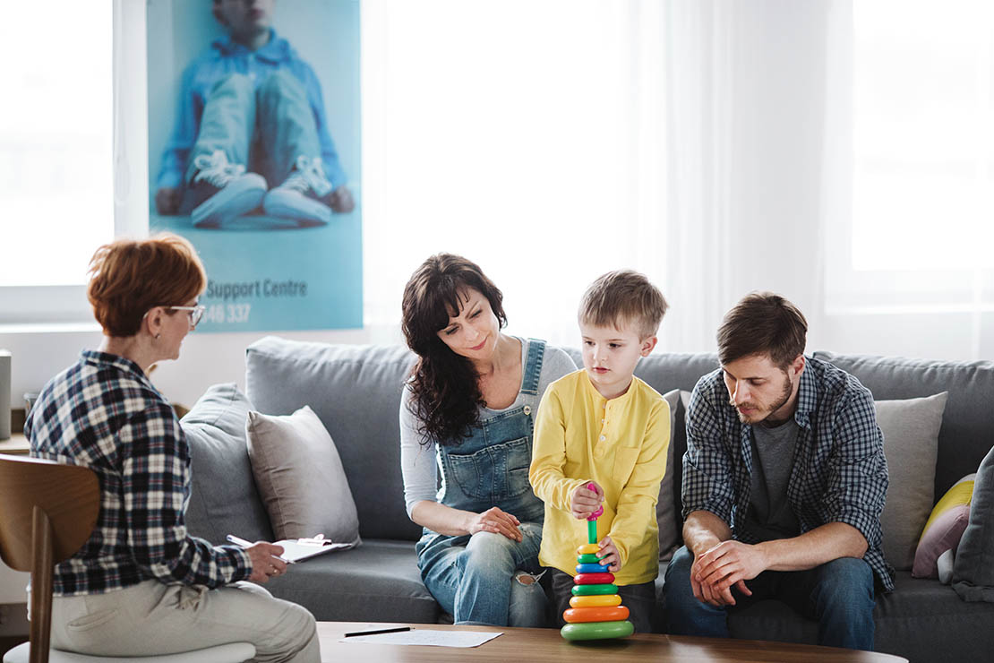 Two adults and child with medical centre staff member