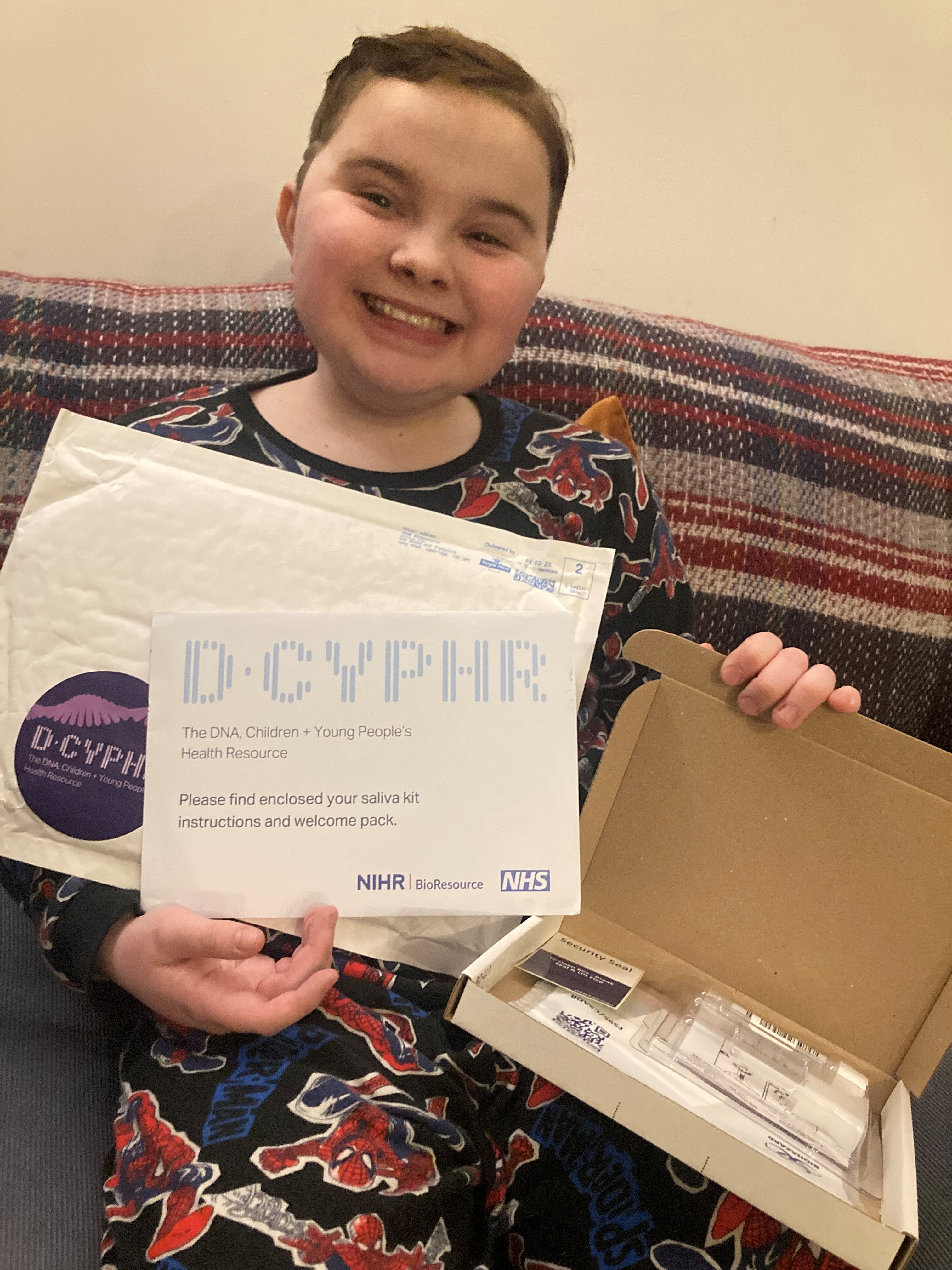 Jenson, a young D-CYPHR volunteer holding sample kit Jenson, a young D-CYPHR volunteer holding sample kit