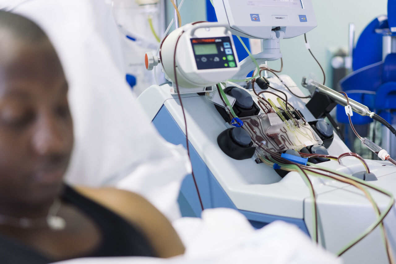 Person in bed undergoing blood transfusion Person in bed undergoing blood transfusion