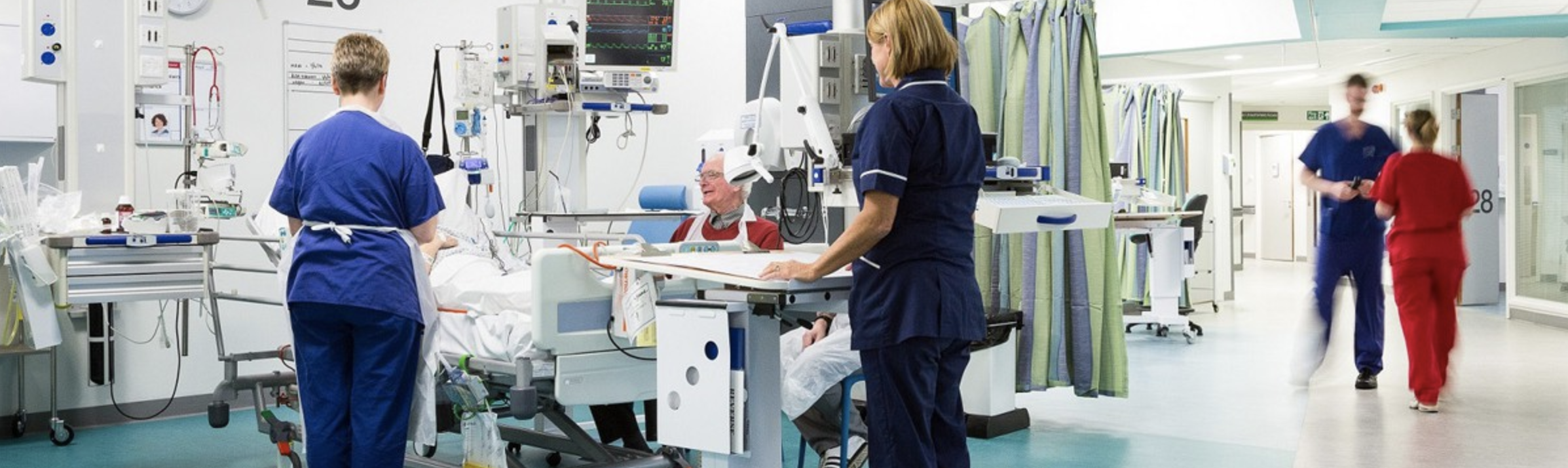 Patient attending clinical appointment being tended to by two nurses