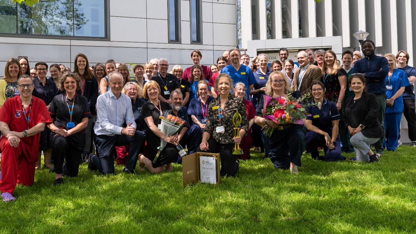 Photo: Exeter CRF celebrating Professor Maggie Shepherd, Exeter’s Trust Consultant Nurse (monogenic diabetes), won the Aster Guardians Global Nursing Award 2023, group shout outside on grass
