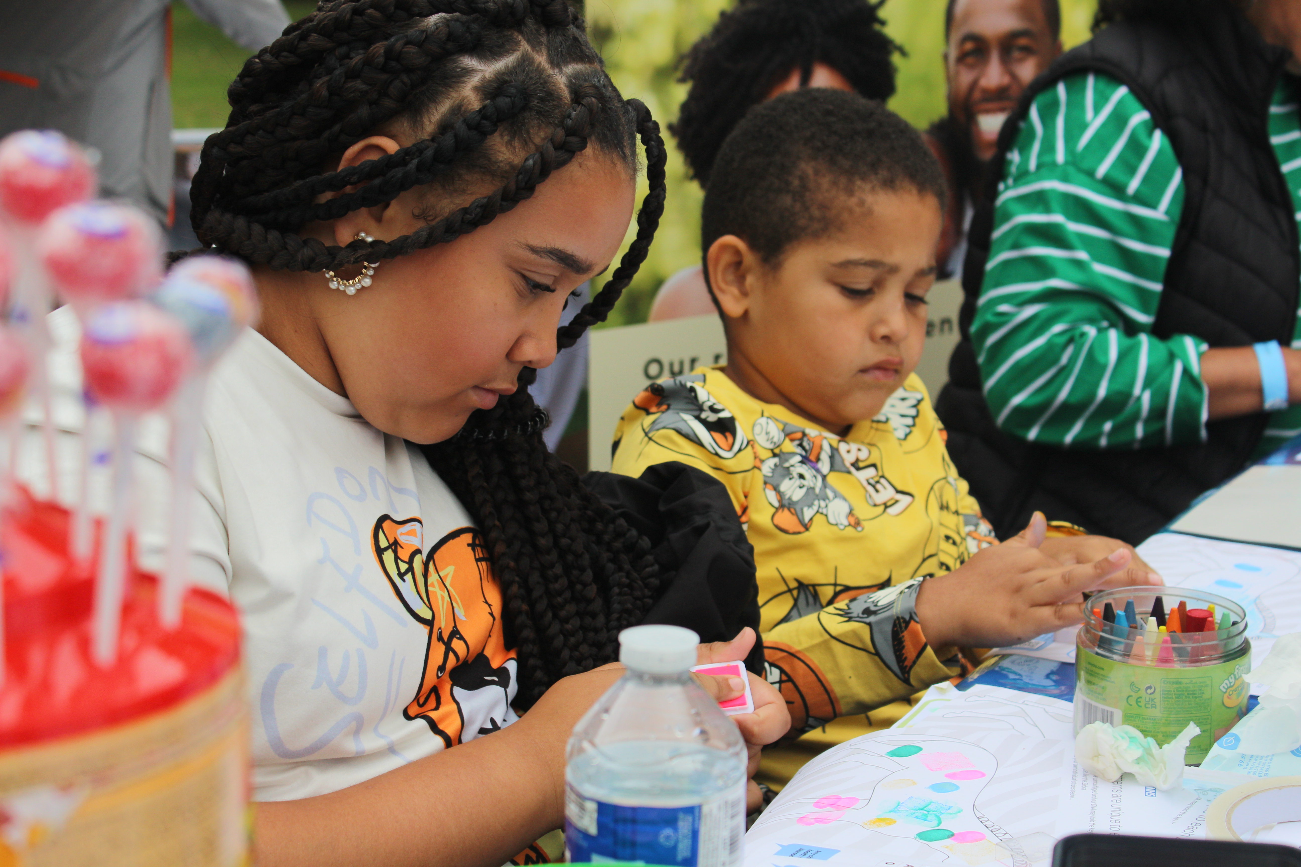 Children doing crafts at the D-CYPHR stall