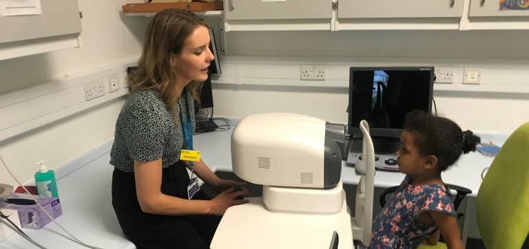 photo of female optician and child patient