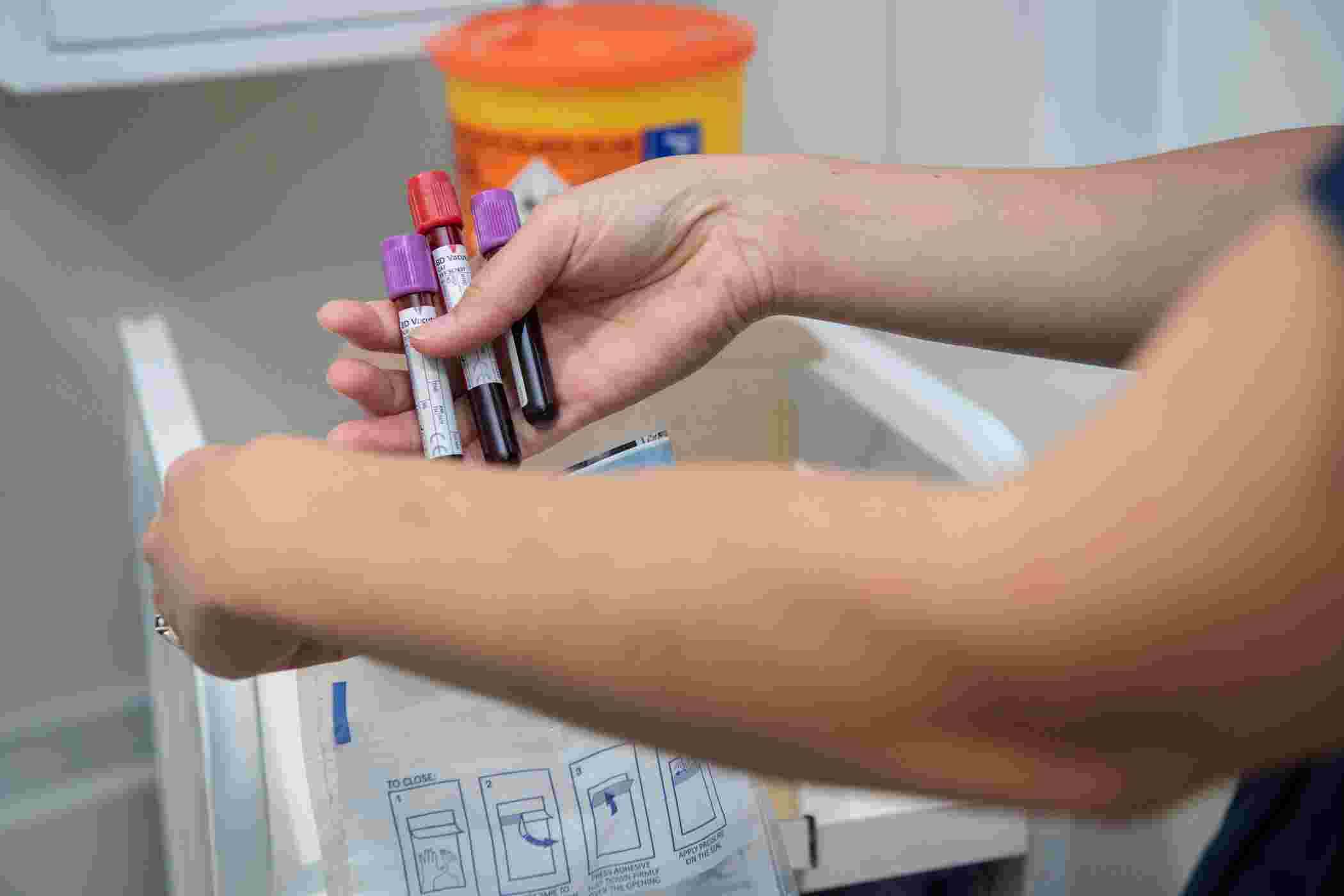 Blood samples in test tubes being placed into a biosample bag
